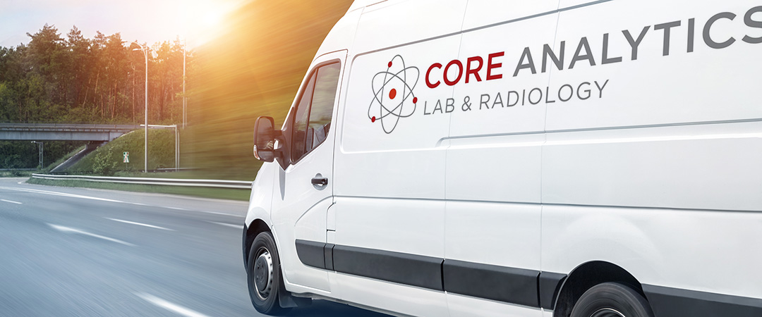 CoreLab-1080x450-2 White van on the freeway with setting sun and overpass in the background